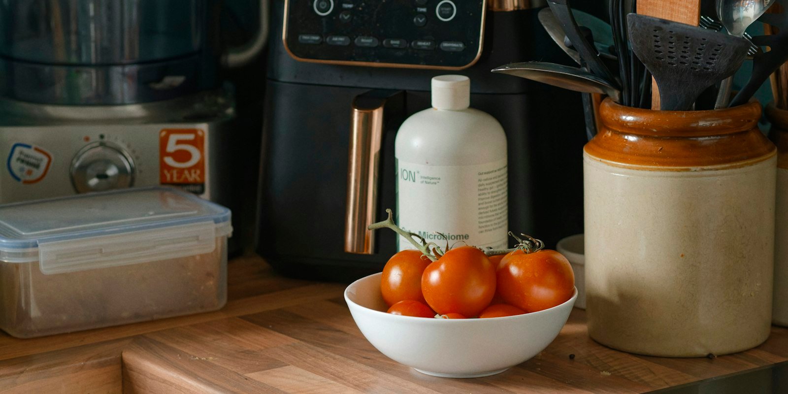 Small kitchen appliances lined up on a counter