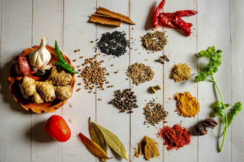 Small bowls of ground spices on a wooden table