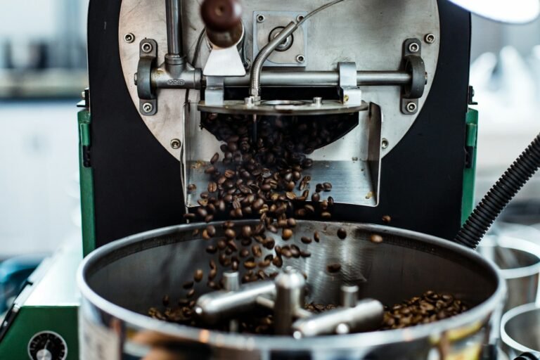 Coffee beans being ground in a burr grinder