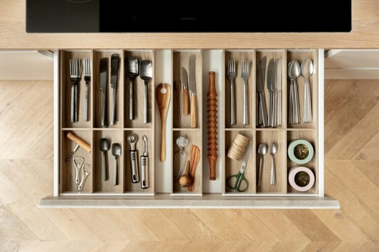 A tidy kitchen cutlery drawer with wooden inserts